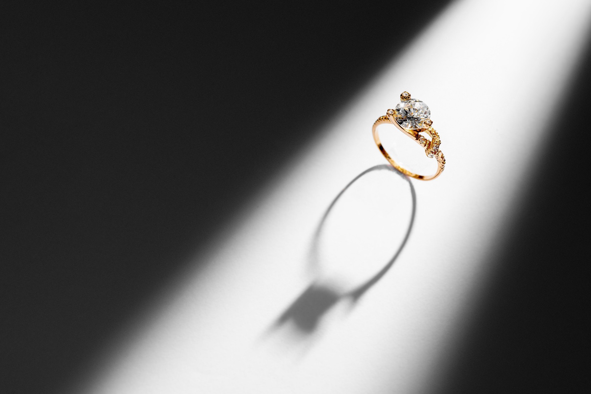 Elegant gold diamond ring on contrasting background